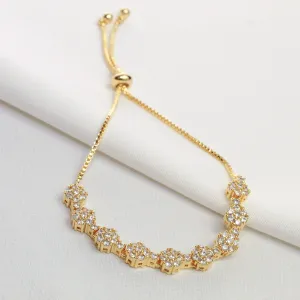 PULSEIRA FLOR CRAVEJADA COM ZIRCÔNIAS CRISTAIS FECHO GRAVATINHA BANHO OURO 18K