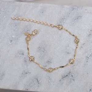 PULSEIRA TORCIDA COM TREVINHOS CRISTAIS BANHO OURO 18K