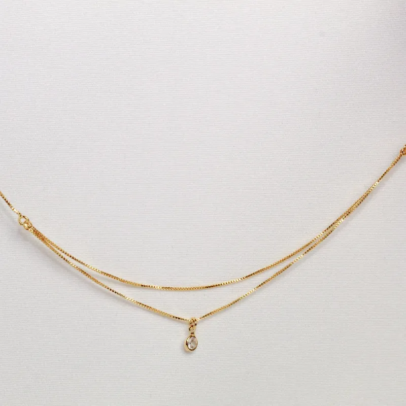 TORNOZELEIRA DUPLA COM UM CRISTAL BANHO OURO 18K