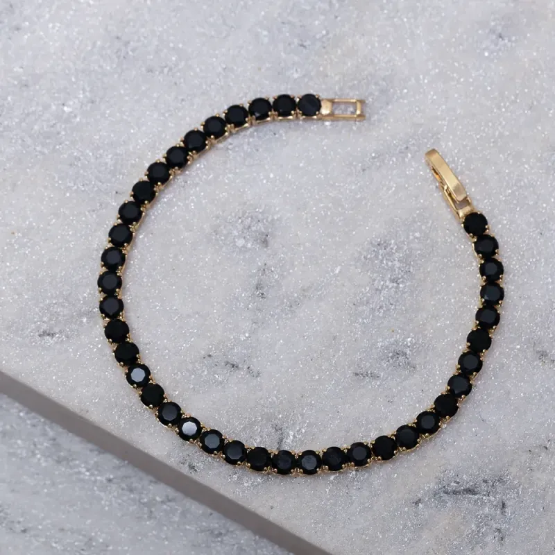 PULSEIRA RIVIERA COM PEDRAS NEGRAS BANHO OURO 18K