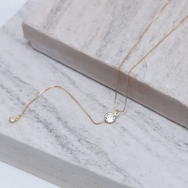 COLAR PÊNDULO COM PONTO DE LUZ CRISTAL BANHO OURO 18K