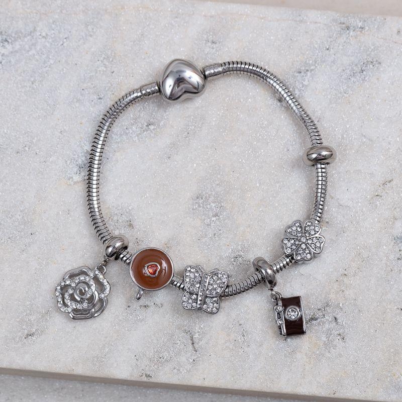 PULSEIRA COM 6 BERLOQUES COR MARROM AÇO INOX