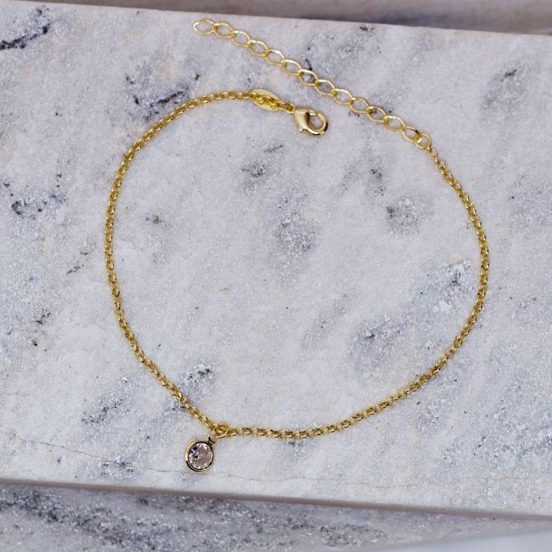 TORNOZELEIRA COM PONTO DE LUZ CRISTAL BANHO OURO 18K