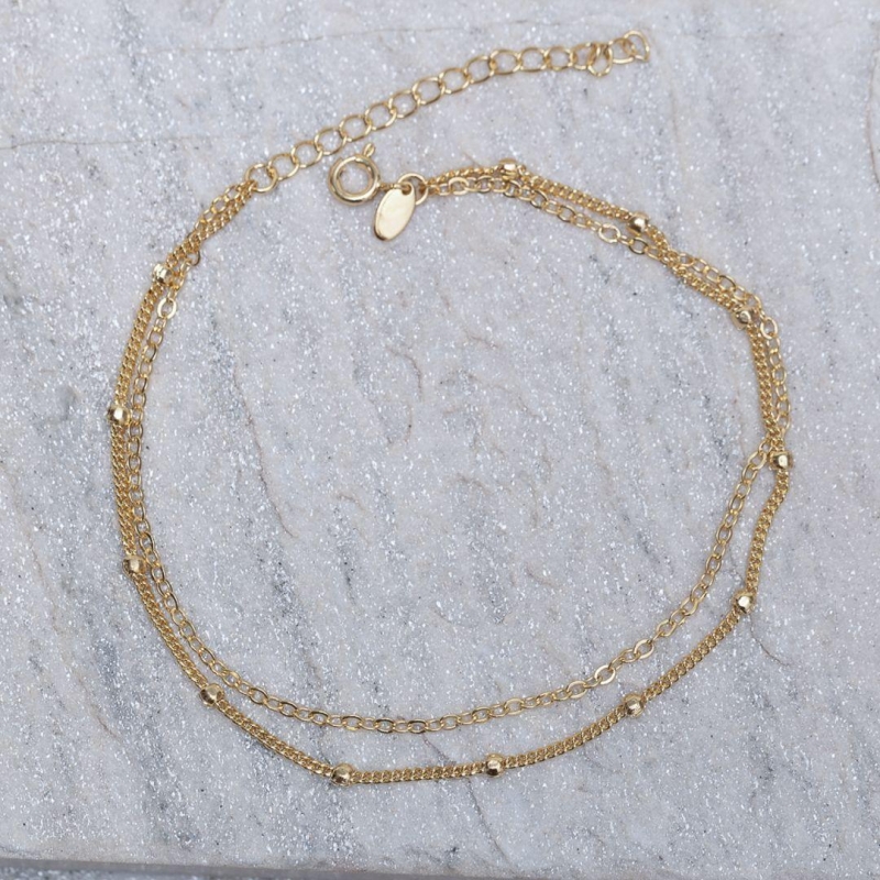 TORNOZELEIRA DUPLA COM BOLINHAS BANHO OURO 18K