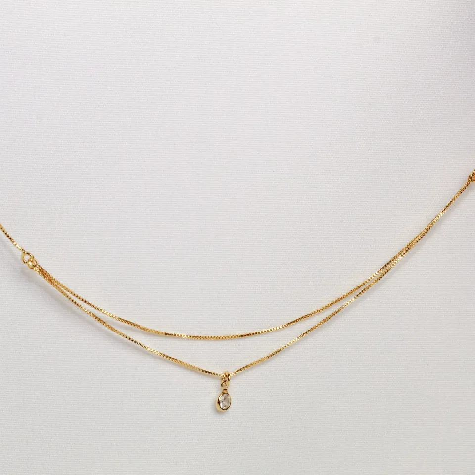 TORNOZELEIRA DUPLA COM UM CRISTAL BANHO OURO 18K