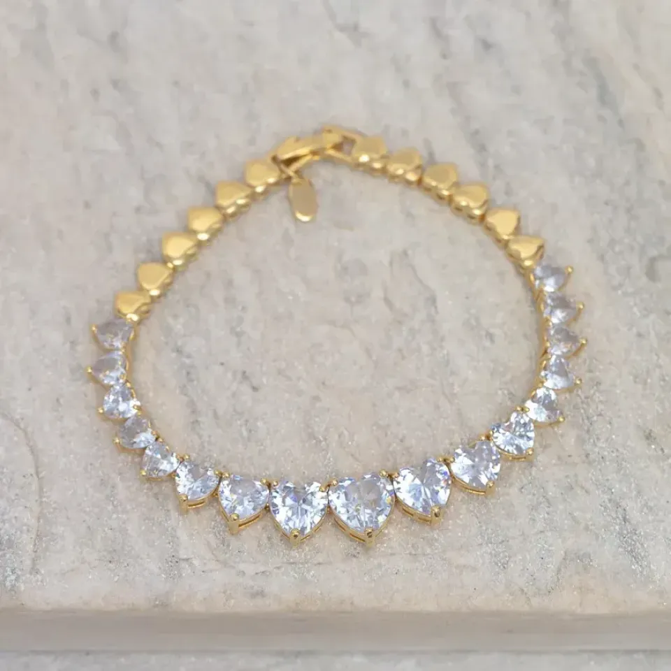 PULSEIRA CORAÇÃO RIVIERA COM PEDRAS CRISTAS BANHO OURO 18K