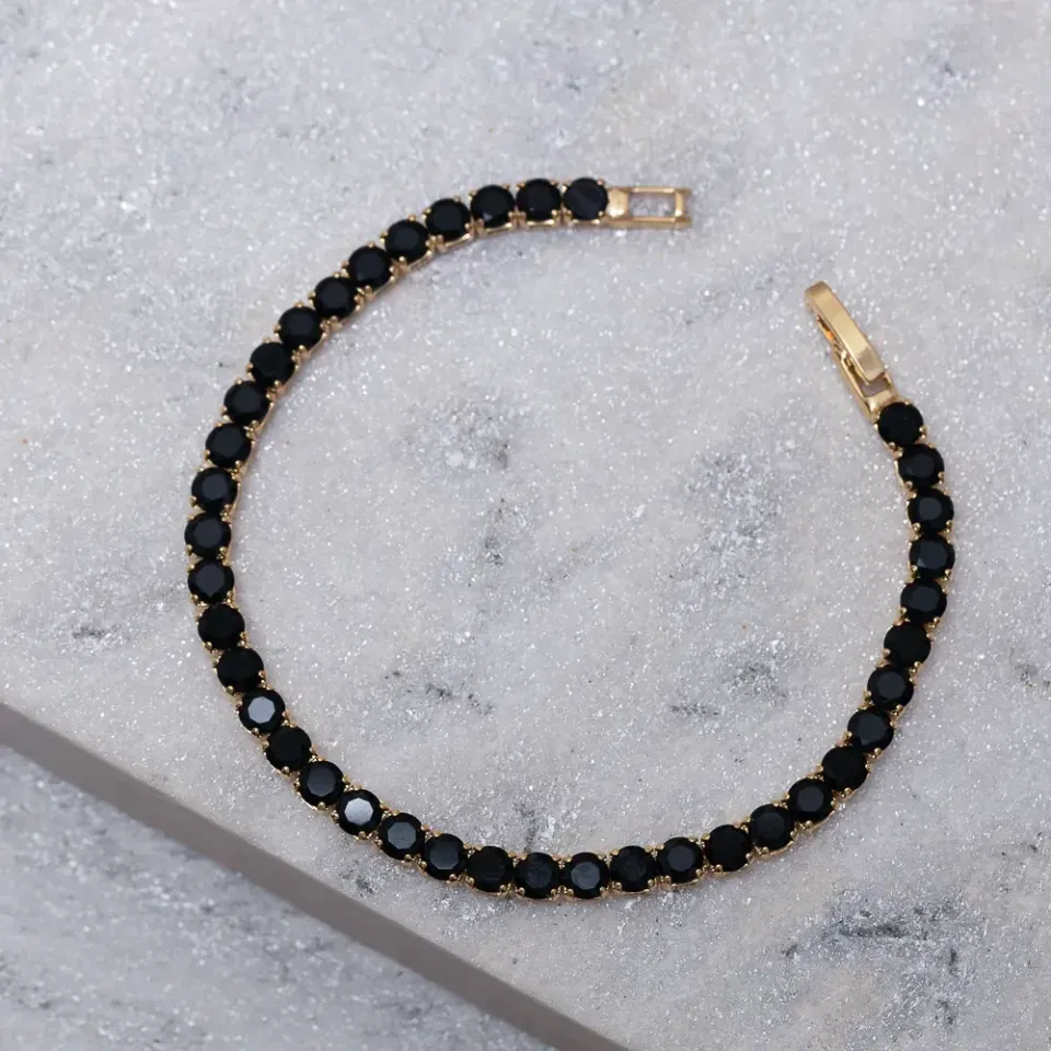 PULSEIRA RIVIERA COM PEDRAS NEGRAS BANHO OURO 18K
