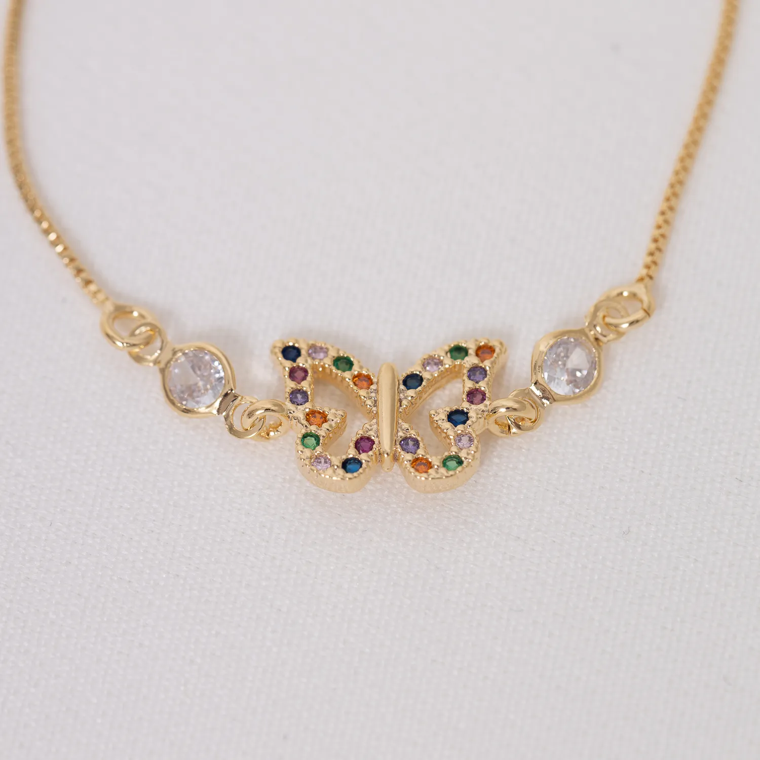 PULSEIRA BORBOLETA COM ZIRCÔNIAS COLORIDAS BANHO OURO 18K