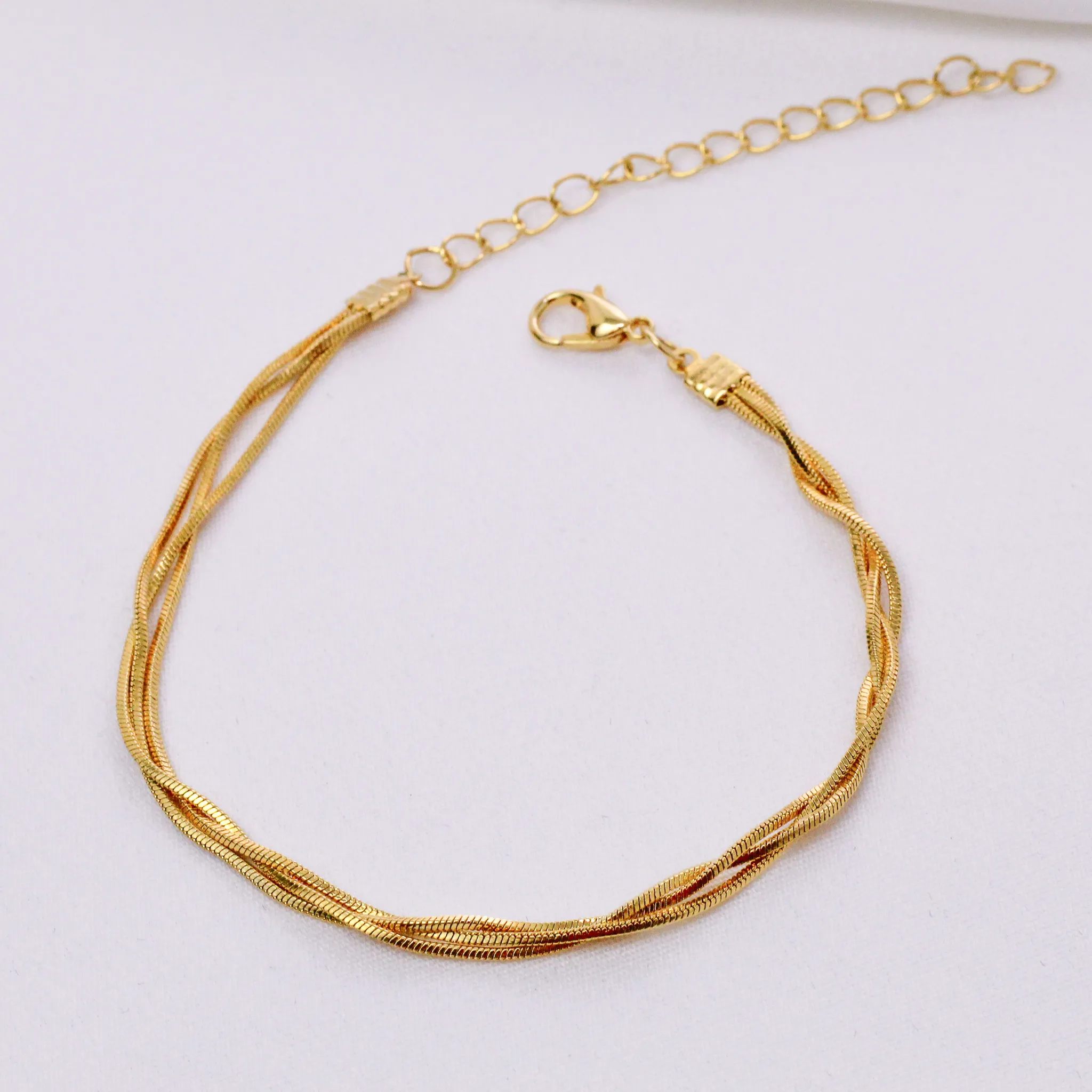 PULSEIRA TRANÇADA FINA BANHO OURO 18K