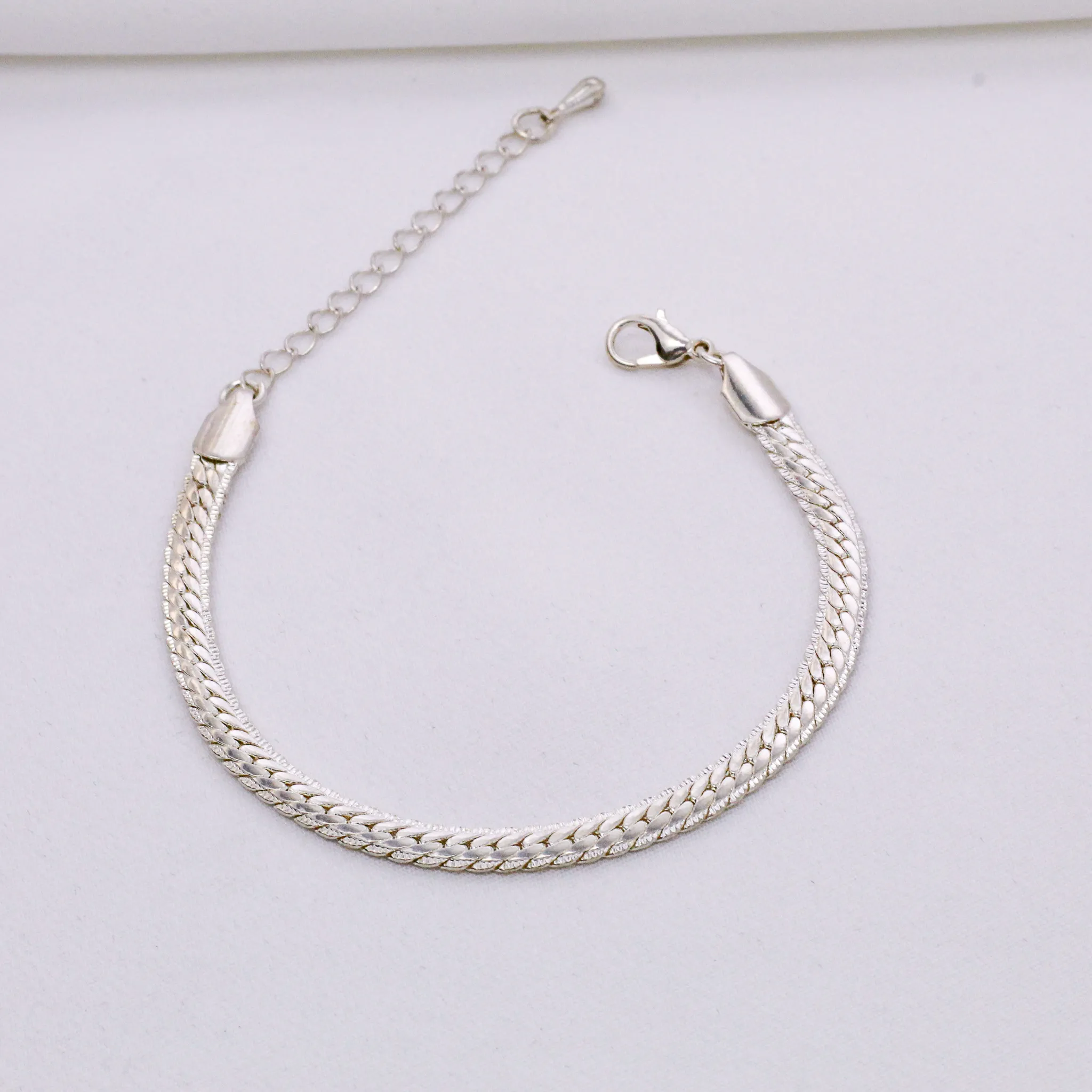 PULSEIRA TRANÇADA BANHO PRATA