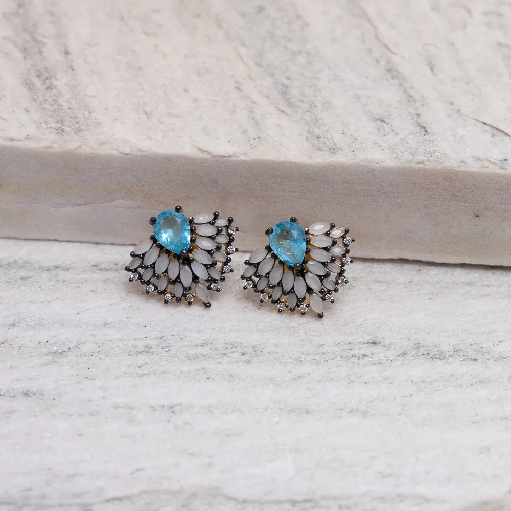 BRINCO COM PEDRA AZUL E CANETA RÓDIO NEGRO BANHO OURO 18K
