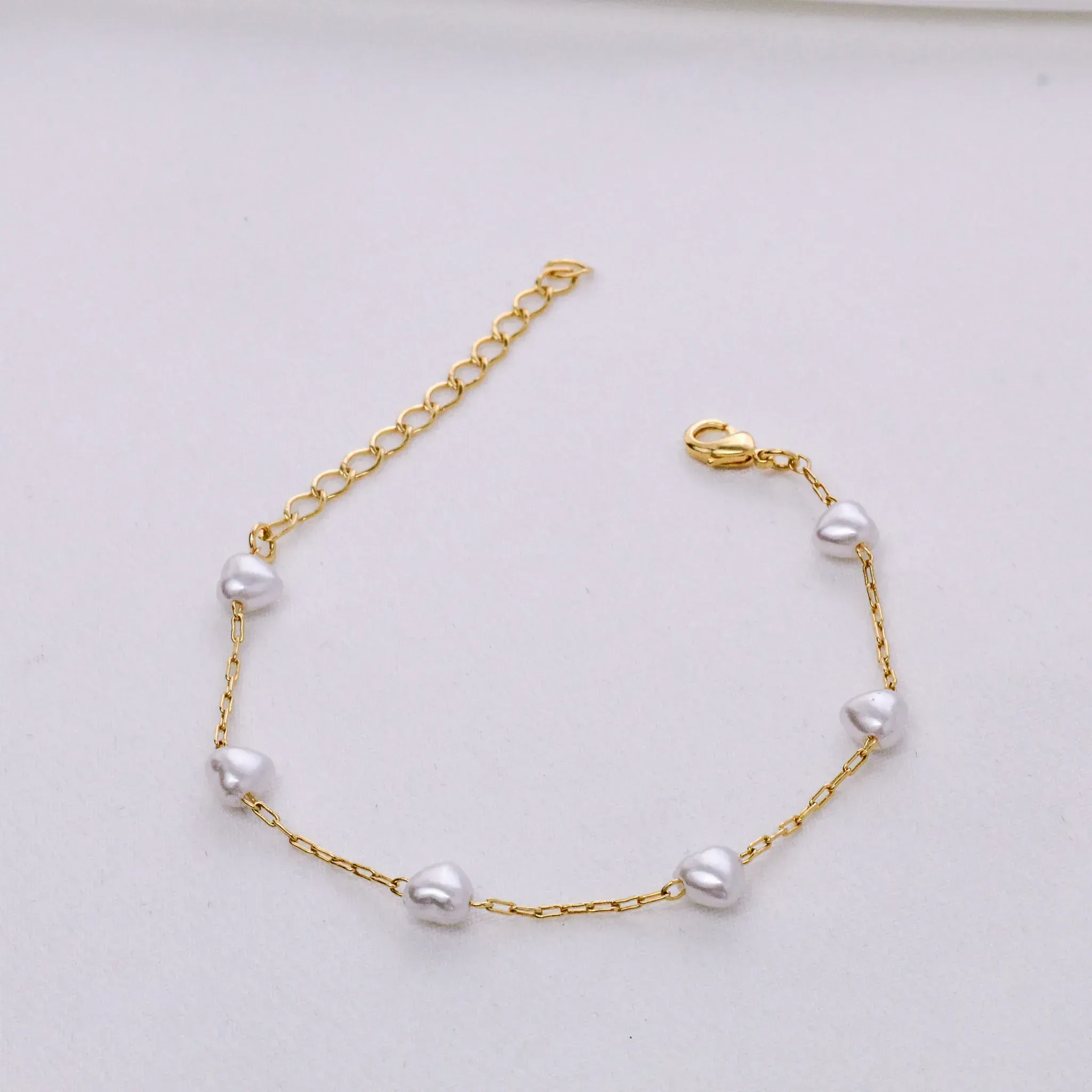 PULSEIRA PÉROLA CORAÇÃO BANHO OURO 18K