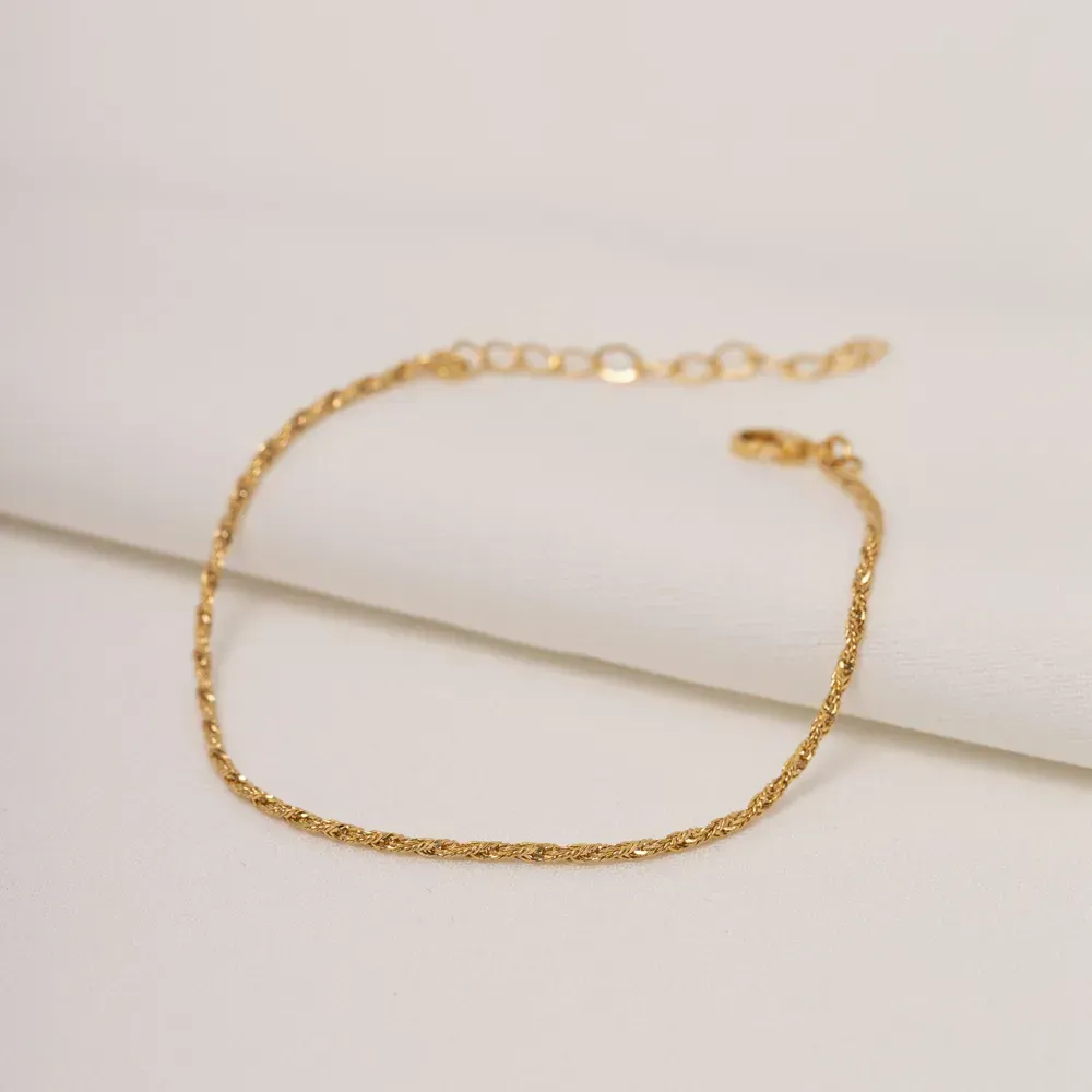 PULSEIRA TORCIDA FINA BANHO OURO 18K
