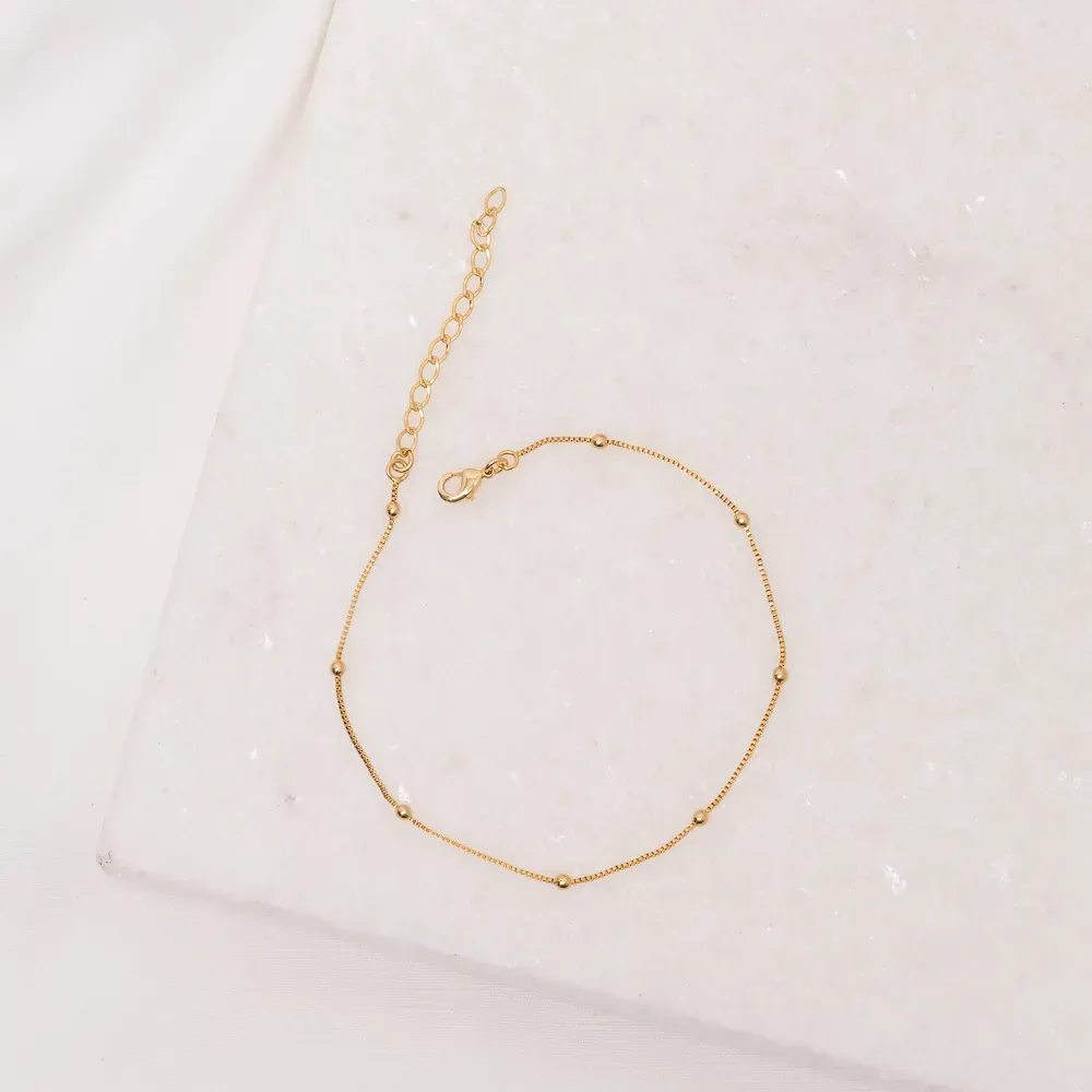 TORNOZELEIRA COM BOLINHAS BANHO OURO 18K