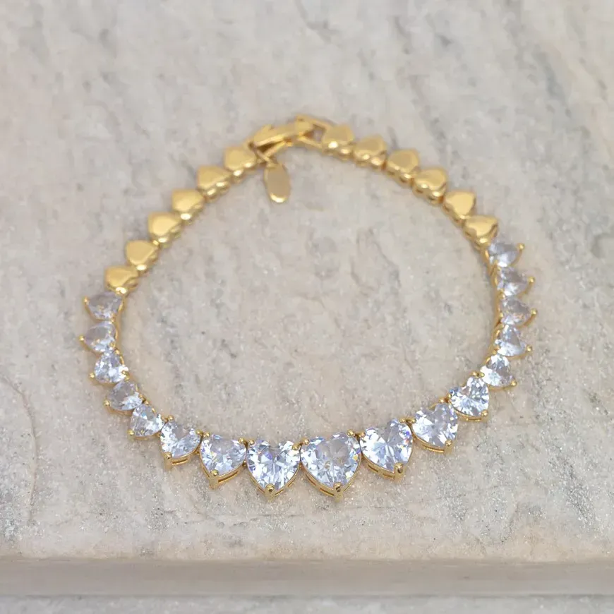 PULSEIRA CORAÇÃO RIVIERA COM PEDRAS CRISTAS BANHO OURO 18K