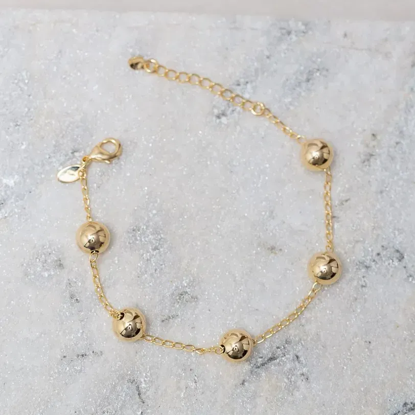 PULSEIRA BOLINHAS M LISAS BANHO OURO 18K