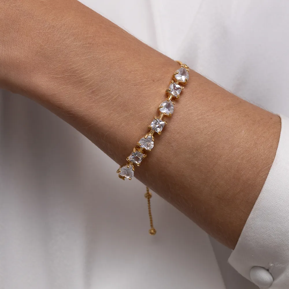 PULSEIRA CORAÇÃO COM PEDRAS CRISTAL FECHO GRAVATINHA BANHO OURO 18K