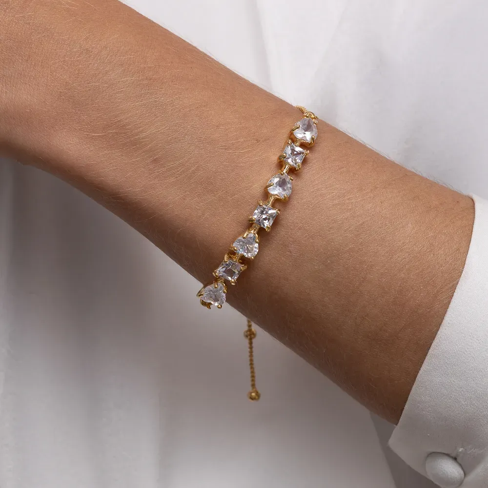 PULSEIRA CORAÇÃO COM PEDRAS CRISTAL FECHO GRAVATINHA BANHO OURO 18K