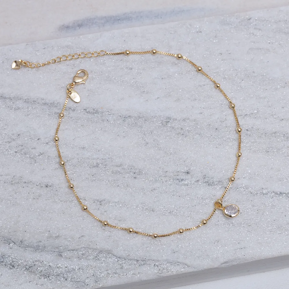 TORNOZELEIRA BOLINHAS COM PONTO DE LUZ BANHO OURO 18K