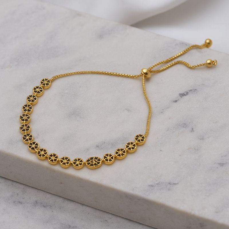 PULSEIRA COM ZIRCÔNIAS NEGRAS FECHO GRAVATINHA BANHO OURO 18K