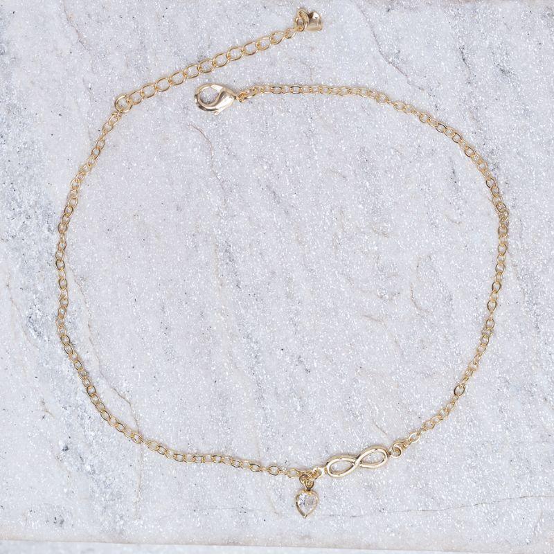 TORNOZELEIRA INFINITO COM PONTO DE LUZ BANHO OURO 18K