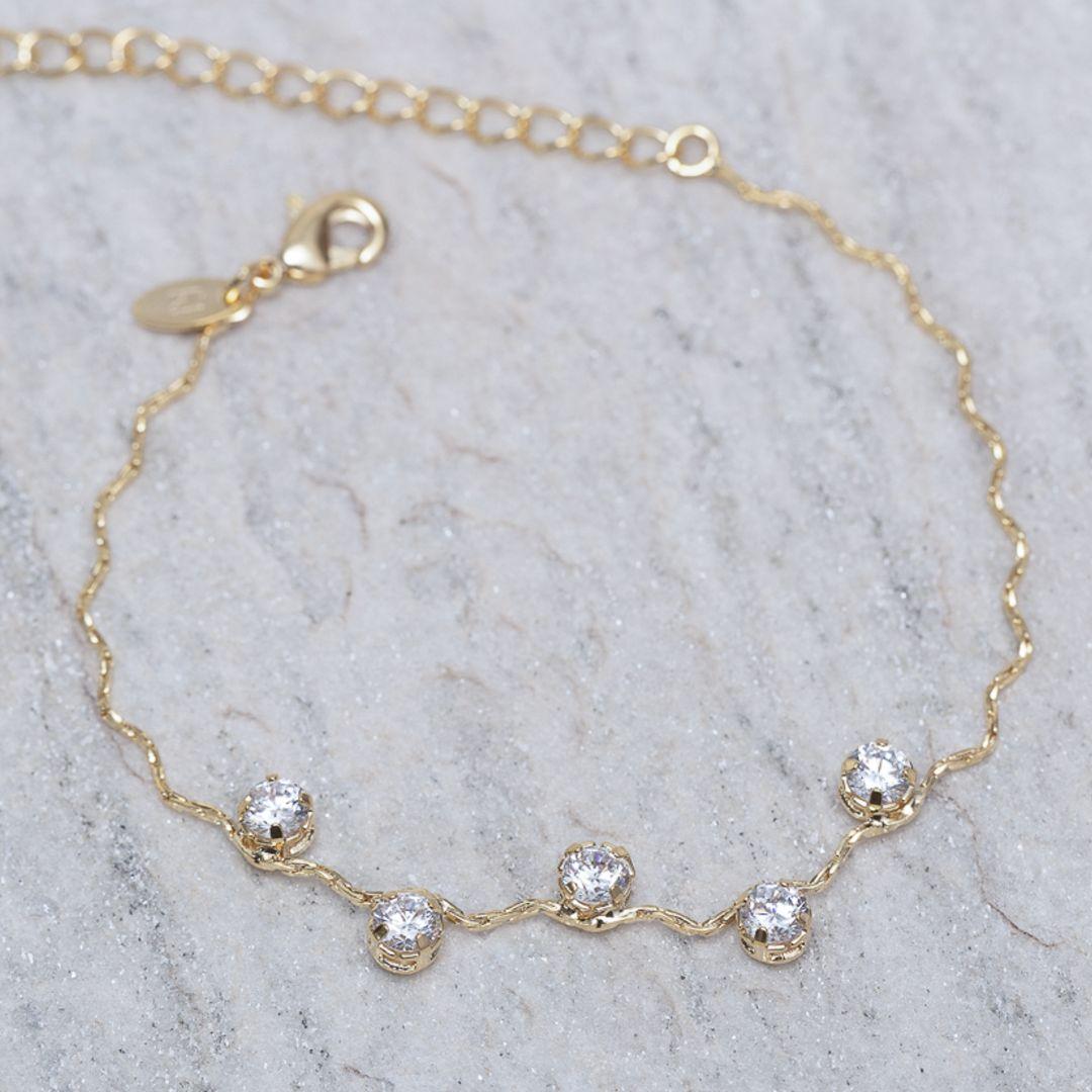 PULSEIRA ONDULADA COM PEDRAS CRISTAIS BANHO 18K
